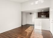 Thumbnail 12 of 33 - A room with wooden floors and a ceiling fan.
