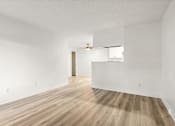 Thumbnail 12 of 36 - A room with wooden flooring and white walls.
