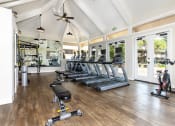 Thumbnail 20 of 25 - Gym with treadmills and ellipticals with screens weight bench, weight machine, rack and stationary bike