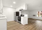 Thumbnail 13 of 36 - A modern kitchen with wooden floors and white appliances.