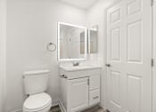 Thumbnail 25 of 36 - A white bathroom with a toilet, sink and mirror.
