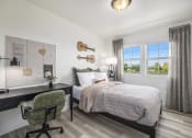 Thumbnail 10 of 51 - a bedroom with a bed and a desk