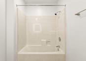 Thumbnail 27 of 36 - A white bathroom with a glass shower door.