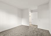 Thumbnail 26 of 36 - A room with a carpeted floor and a white door.