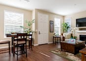 Thumbnail 6 of 29 - A dining room with a table and chairs.