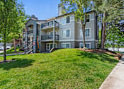 Thumbnail 12 of 52 - A large apartment building with a grassy front yard.