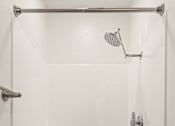 Thumbnail 23 of 33 - A white shower stall with a shower head and a hand held shower.