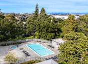 Thumbnail 9 of 55 - Pet-Friendly Affordable Apartments in San Mateo, CA - Hillsdale Garden - Swimming Pool with a Spa, Lounge Seating, and an Aquatic Wheelchair