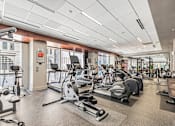 Thumbnail 11 of 33 - A gym with a variety of exercise equipment including treadmills, stationary bikes, and weight machines. at 1600 Glenarm Place, Denver, CO