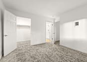 Thumbnail 28 of 36 - A room with white walls and carpeted floor with two doors.