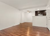 Thumbnail 20 of 33 - A room with wooden flooring and a ceiling fan.