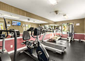 Thumbnail 5 of 36 - A gym with treadmills, elliptical machines, and other exercise equipment.