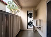 Thumbnail 27 of 33 - A small room with a washing machine and dryer.