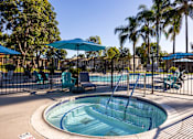 Thumbnail 2 of 36 - A pool with a slide and a fence.