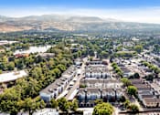 Thumbnail 40 of 46 - A bird's eye view of a residential area with houses and a lake in the distance.