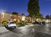 Thumbnail 36 of 36 - A parking lot with cars and apartment buildings in the background.