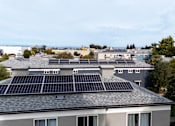 Thumbnail 39 of 55 - A rooftop with solar panels is seen from a distance at Hillsdale Garden Apartments,California 94403