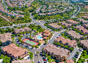 Thumbnail 26 of 29 - A bird's eye view of a residential area with houses and a pool.