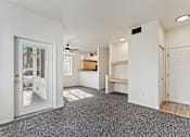 Thumbnail 20 of 36 - A spacious room with a grey carpet and white walls.