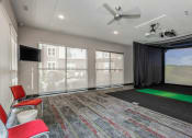 Thumbnail 21 of 24 - a room with a projector screen and chairs and a large window