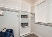 Thumbnail 7 of 24 - a walk in closet with white closets and shelves and a window