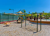 Thumbnail 21 of 29 - A playground with a swing set and a slide.