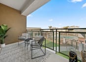 Thumbnail 6 of 36 - a balcony with patio furniture and a view of a pool