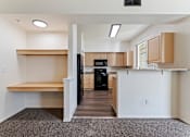 Thumbnail 15 of 36 - A kitchen area with a refrigerator, oven, and microwave.
