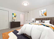 Thumbnail 19 of 55 - A bedroom with a large bed and a painting on the wall.