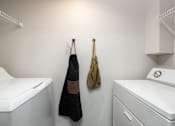 Thumbnail 9 of 48 - In unit washer and dryer with overhead storage at Canyon Creek Apartments, Oregon, 97070