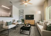 Thumbnail 19 of 38 - a living room with a couch and a coffee table and a television
