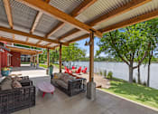 Thumbnail 18 of 52 - A patio with a table and chairs overlooking a lake.