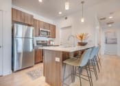 Thumbnail 1 of 34 - a kitchen with wood cabinets and stainless steel appliances