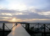 Thumbnail 5 of 18 - a view of the sunset over the water from the top of a bridge