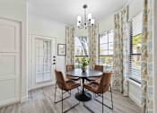 Thumbnail 8 of 48 - A dining room with a round table and chairs.
