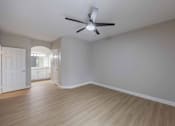 Thumbnail 14 of 30 - A room with a ceiling fan and light fixture.