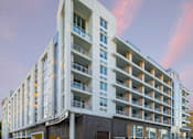 Thumbnail 34 of 34 - A modern apartment building with balconies and multiple floors.