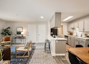 Thumbnail 14 of 48 - Open concept living and kitchen with island seating at Canyon Creek Apartments, Wilsonville