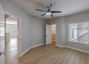 Thumbnail 15 of 30 - A room with a ceiling fan and a window with blinds.