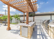 Thumbnail 6 of 24 - the outdoor patio has a grill and a table with a tv