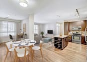 Thumbnail 3 of 28 - A modern kitchen with a dining table and chairs.
