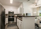 Thumbnail 3 of 38 - the preserve at ballantyne commons apartment kitchen with stainless steel appliances