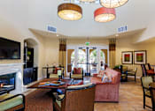 Thumbnail 11 of 29 - Clubhouse with couches and dining, fireplace