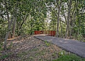 Thumbnail 37 of 37 - A bridge made of wood is in the middle of a forest.