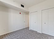 Thumbnail 26 of 36 - A room with white walls and a grey carpet.