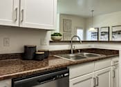 Thumbnail 31 of 38 - a kitchen with white cabinets and a sink and a counter top
