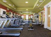 Thumbnail 3 of 29 - A gym with treadmills and exercise equipment.