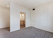 Thumbnail 31 of 36 - A large empty room with a doorway leading to another room.
