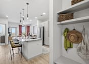 Thumbnail 1 of 55 - A kitchen with a white counter and a stool.