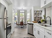 Thumbnail 5 of 48 - A modern kitchen with a dining table and chairs.
